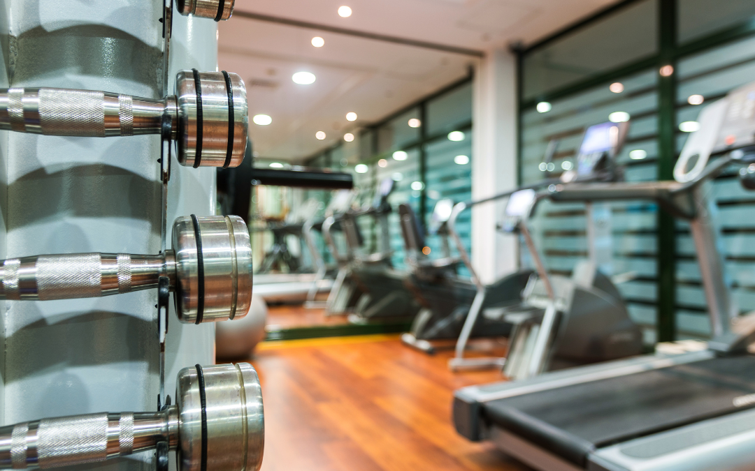 Treadmill and dumbbells side by side, emphasizing a balanced fitness approach.